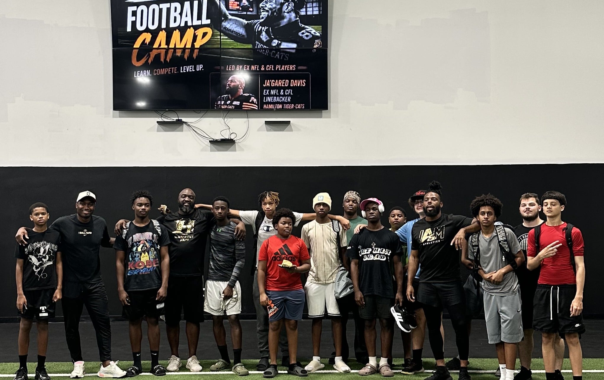 A group of kids with their coaches after a camp at I Am Athletics
